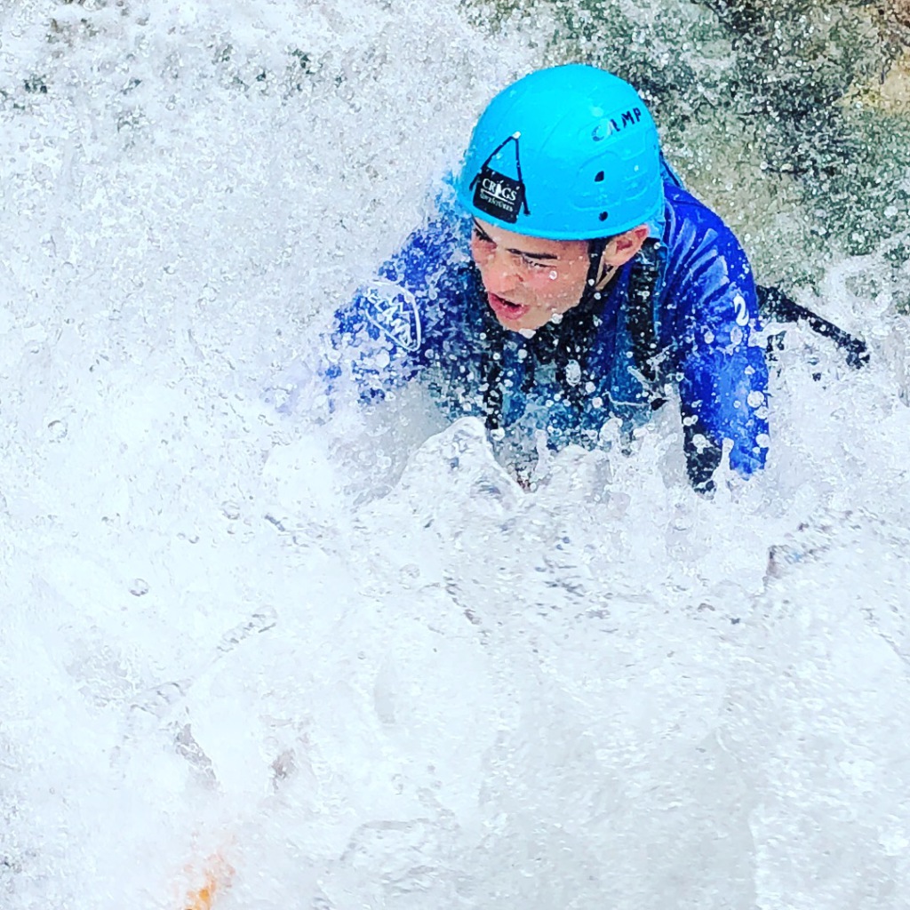 person ghyll scrambling in high water