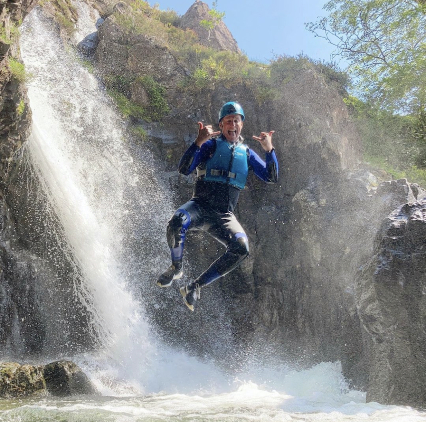 Picture of a man free-falling into a waterfall