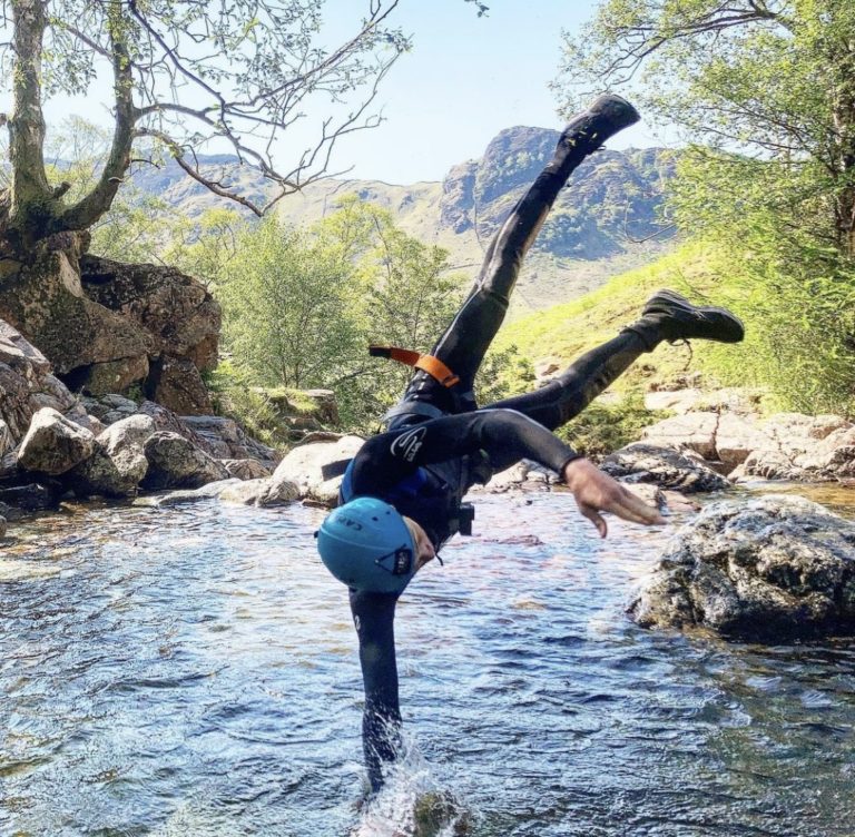 person diving into a natural pool whilst ghyll scrambling in Stickle Ghyll