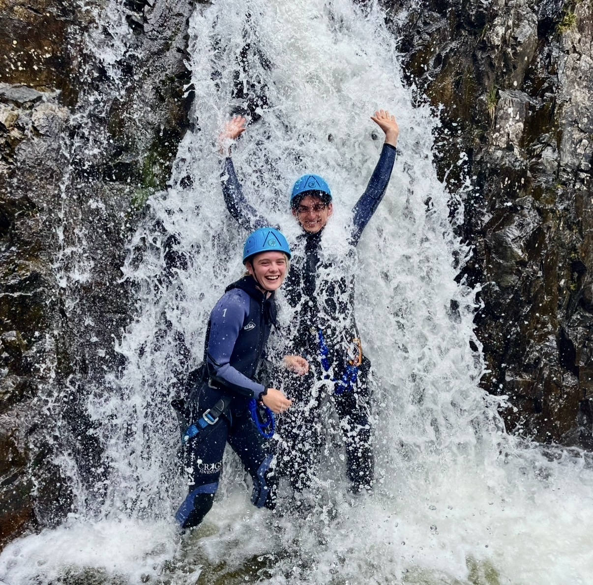 cheering under a waterfall at stickle ghyll