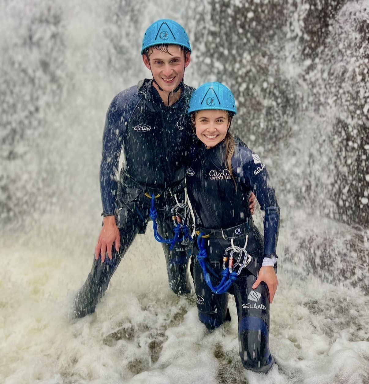 couple smiling during a ghyll scramble at stickle ghyll in the lake district