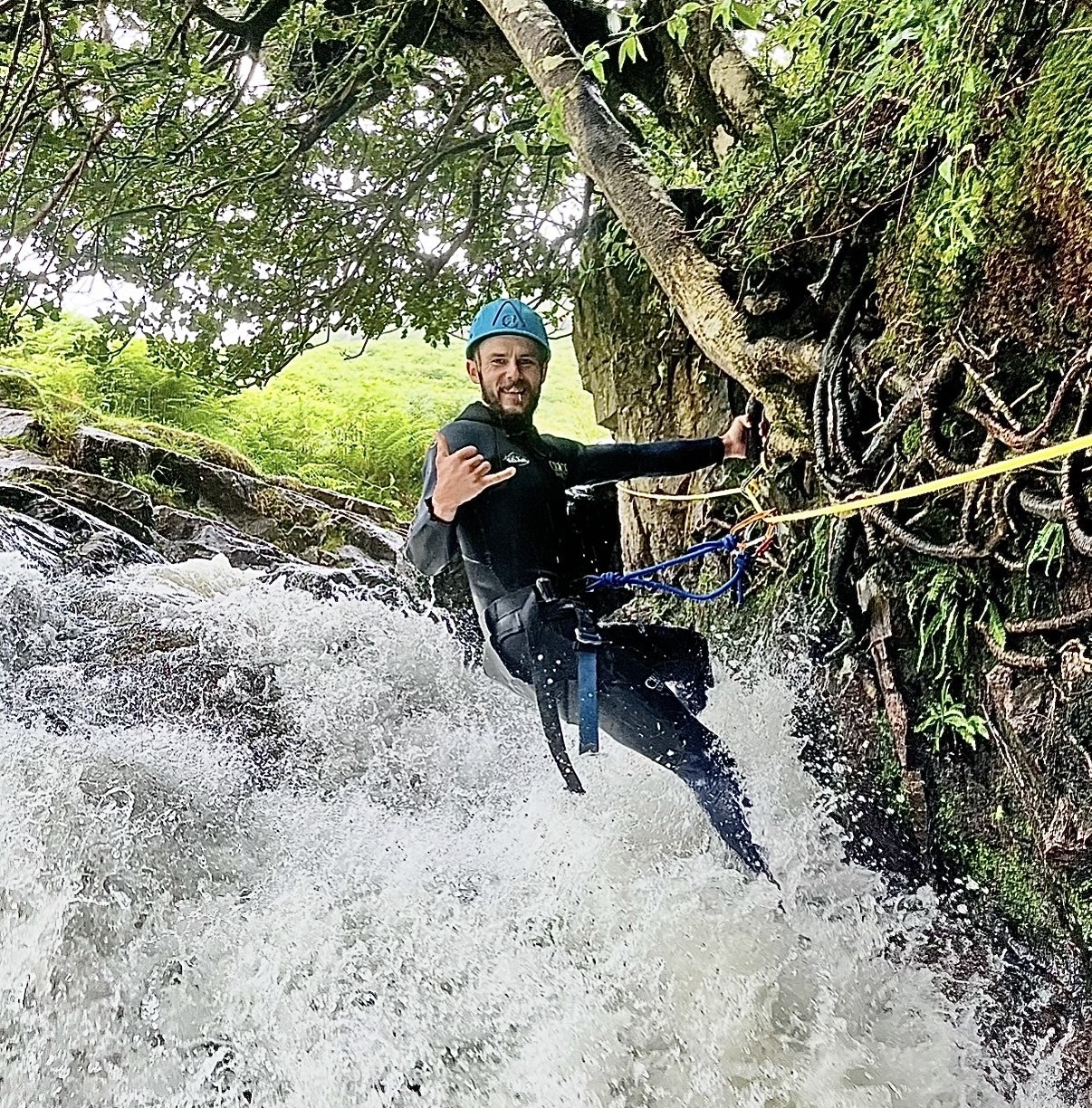 a man climbing a small waterfall