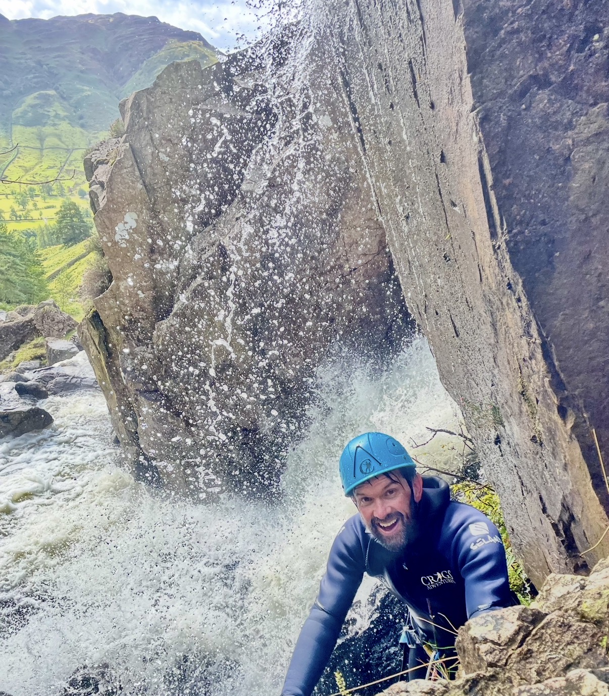 a man climbing a waterfall