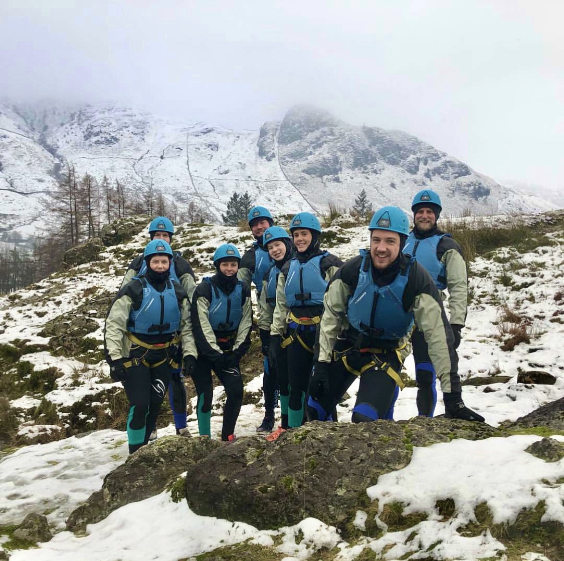a group with full Winter equipment on standing on snow covered ground