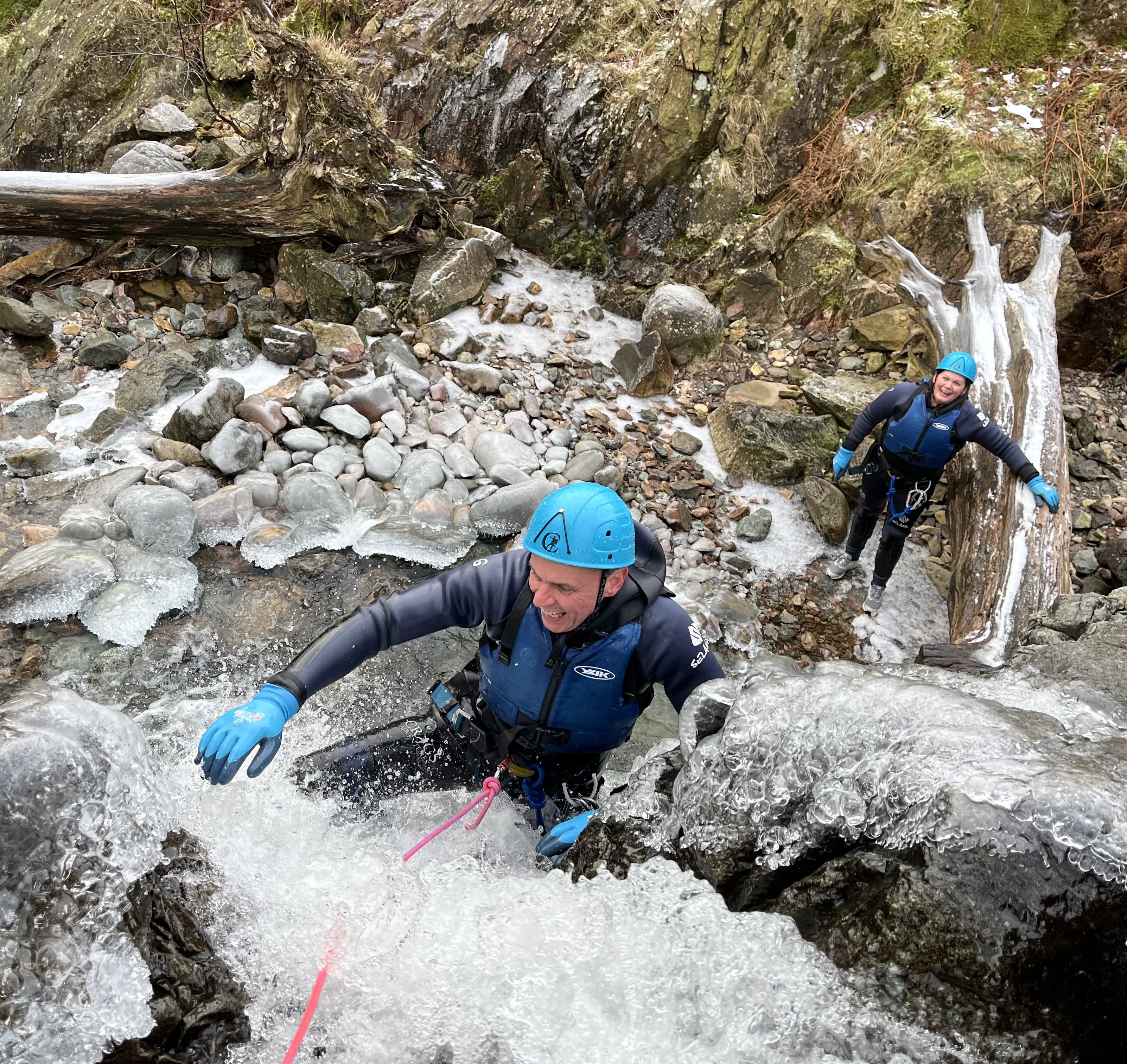 a person at the top of an icy waterfall whilst canyoning with Crags Adventures in the Lake District
