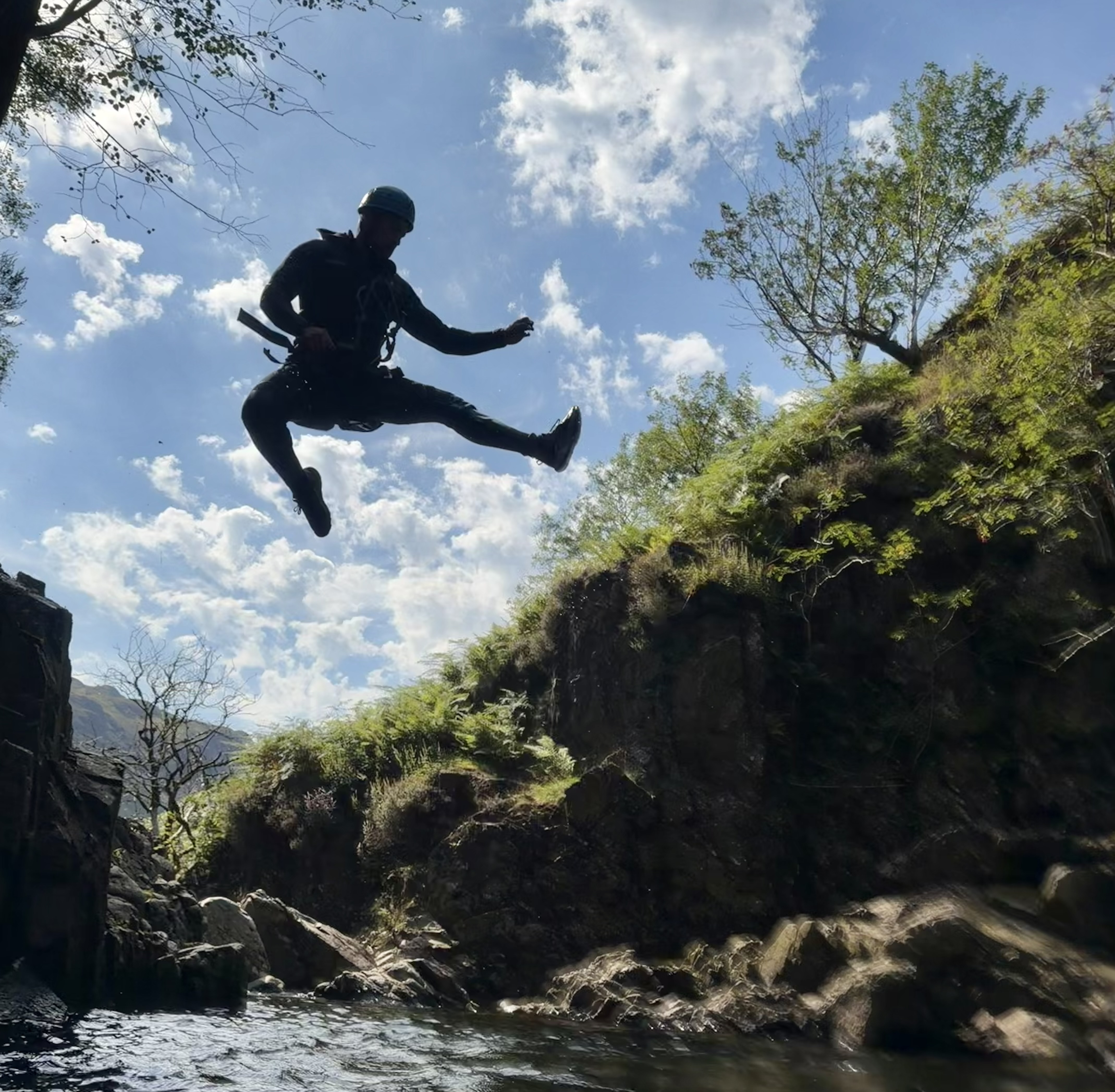 a person doing a pose mid jump, in Esk ghyll