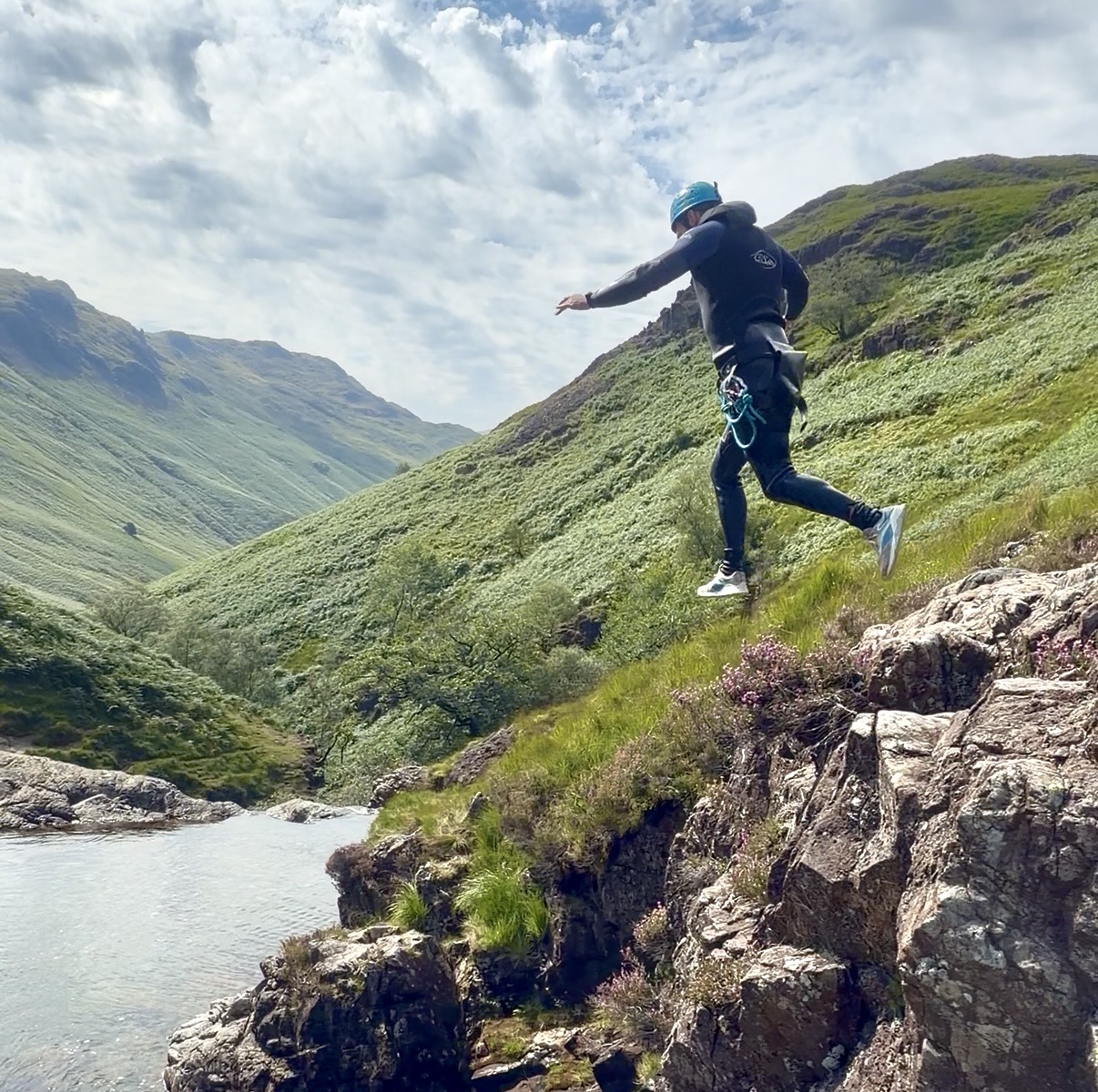 a man steps off a cliff jump and looks like he's suspended in mid air