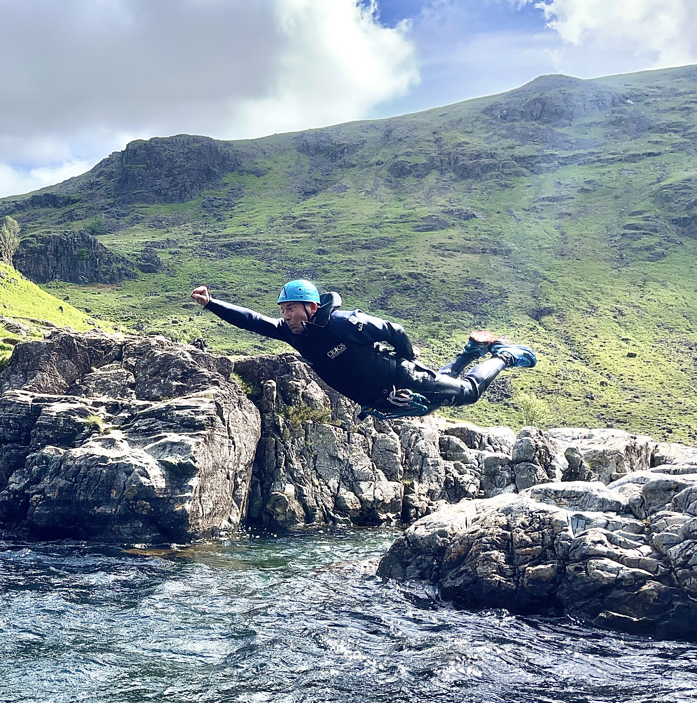 a man performing a superman while diving into a pool of water